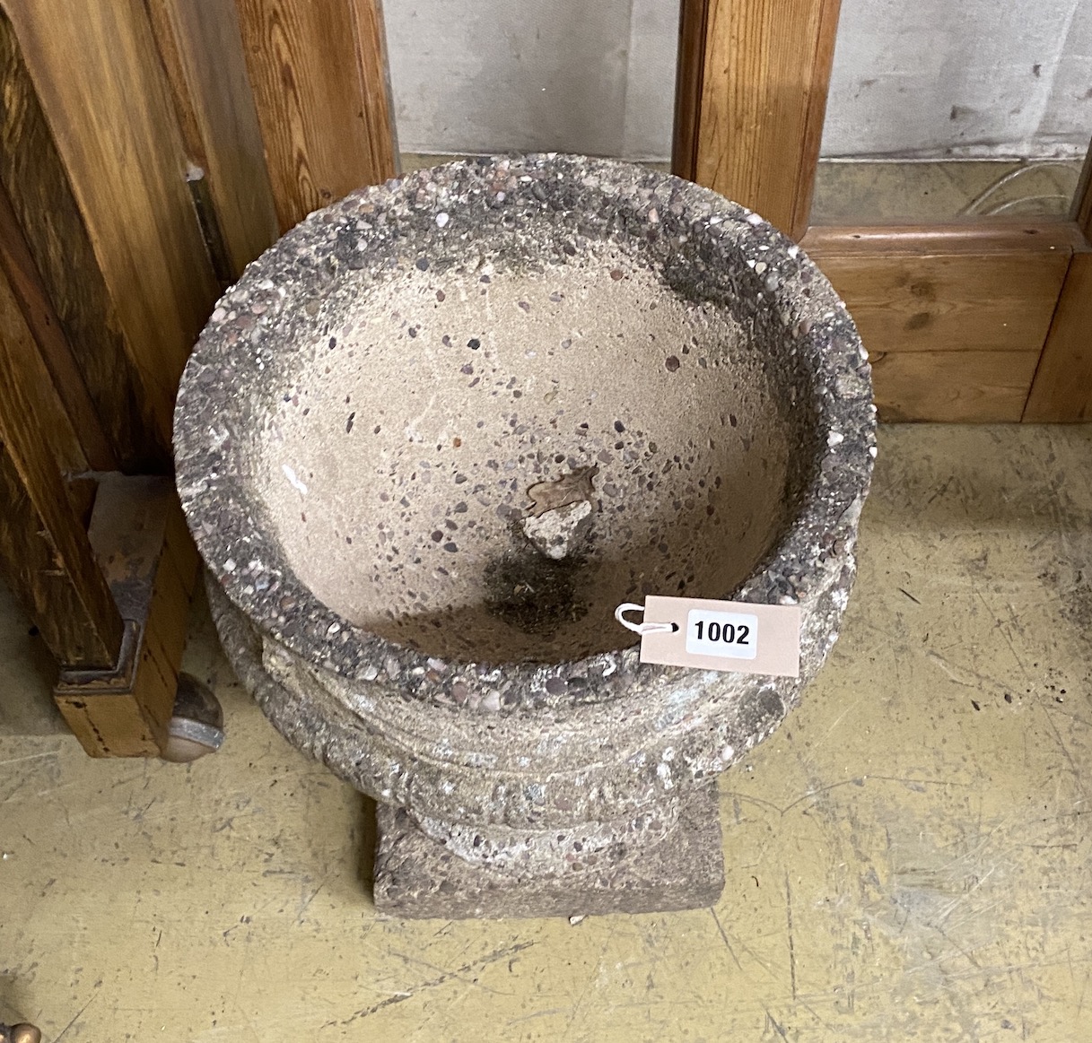 A circular reconstituted stone garden planter with swagged body, diameter 35cm, height 43cm